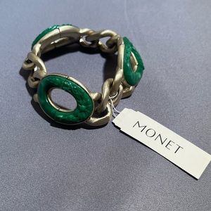 Metal Monet bracelet with green accents.